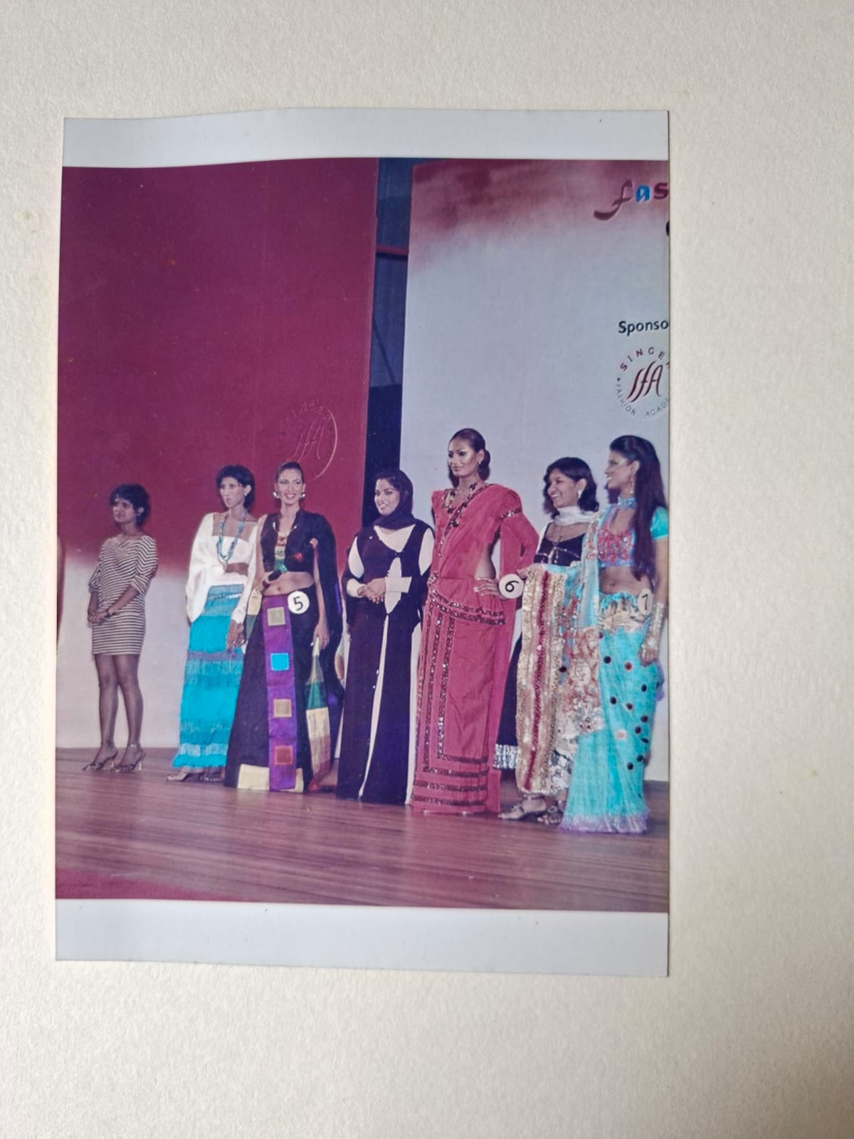 Models lined up on stage at the close of a fashion design competition