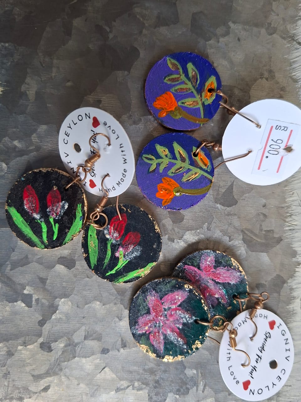 Hand painted wooden earrings with tulips, lilies and marigolds on dark grounds