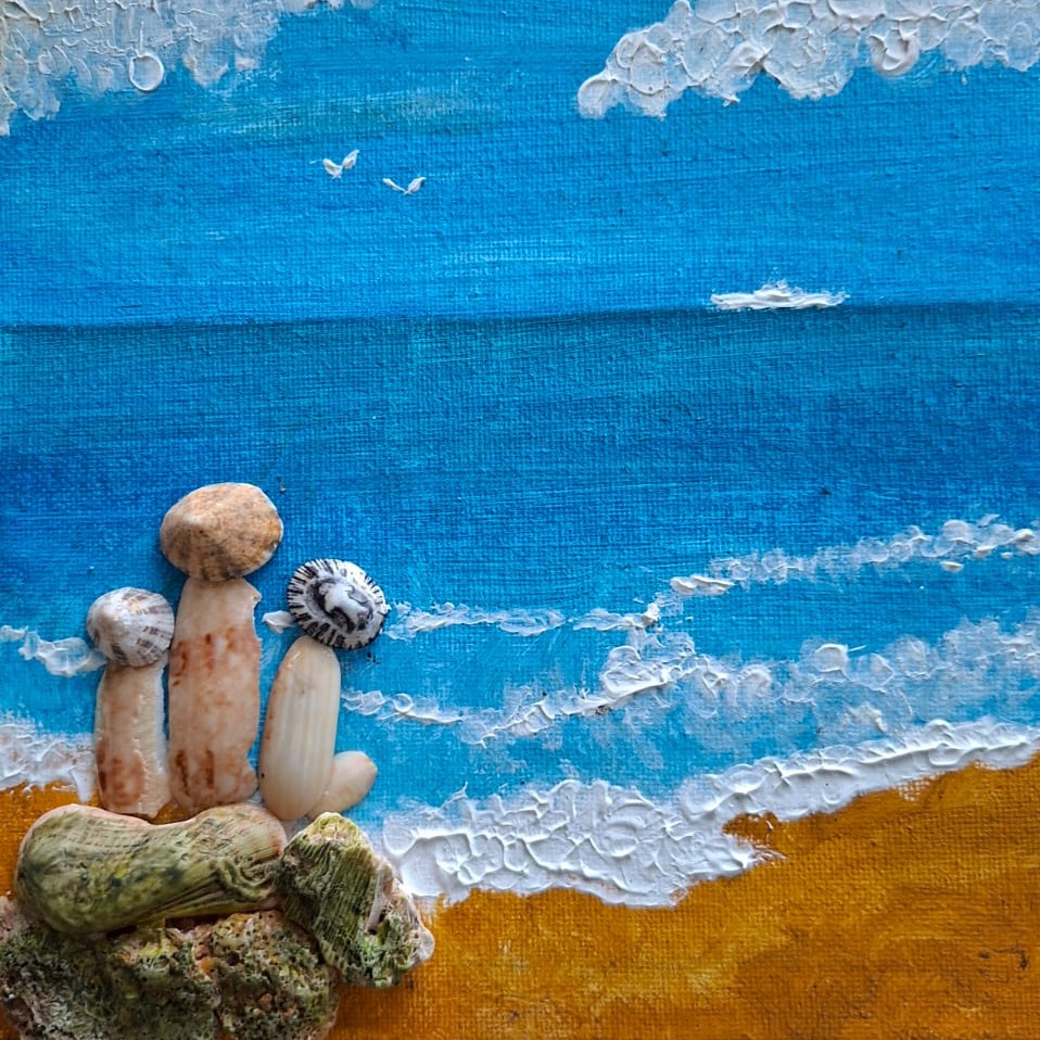 Shell canvas painting of beach figures