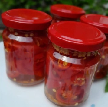 Glass jars filled with red chilli preserves
