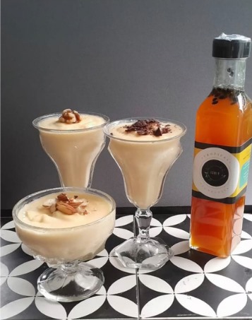 Dessert glasses layered with fruit and sauce