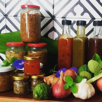 A range of homemade preserve jars displayed on a tile