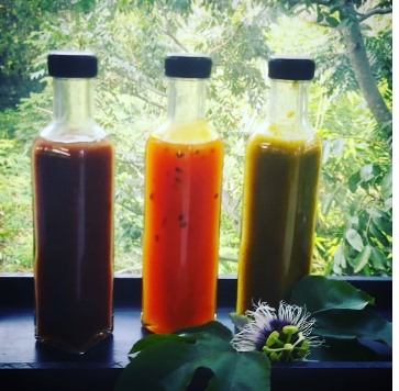Bottles of homemade sauce catching light in a window