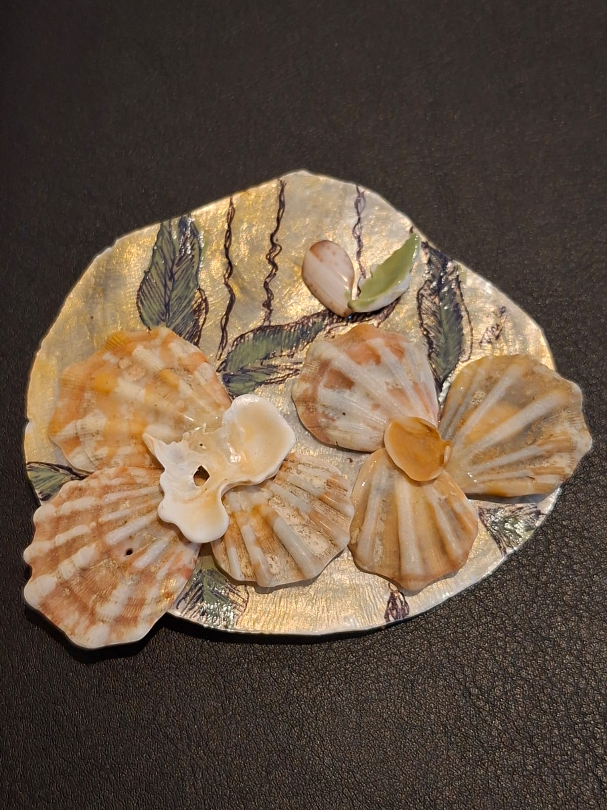 A gilded shell dish painted with fronds and set with scallop shells