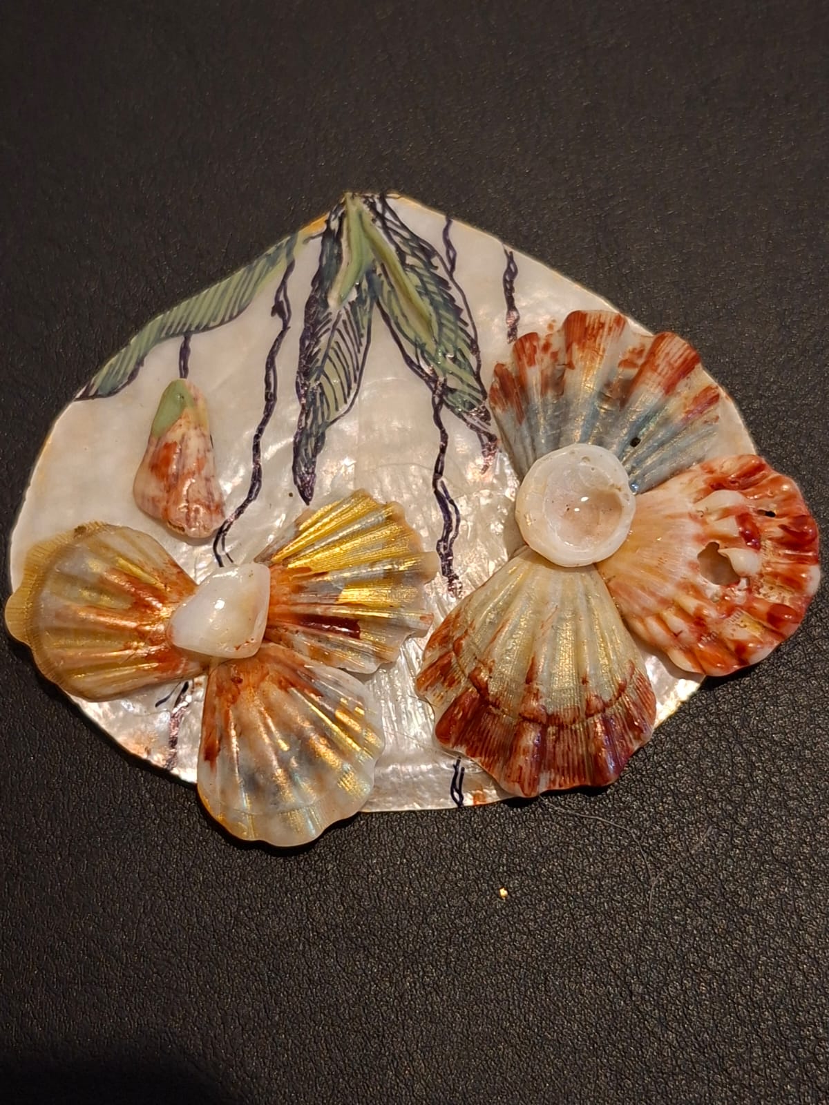 A pearl dish with painted seagrass and two shell blossoms