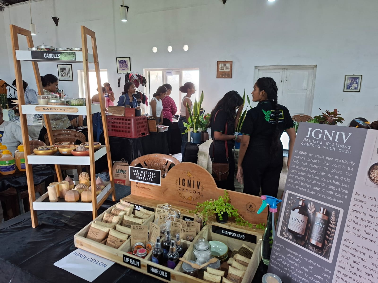 Shoppers browsing a handmade bath and body stall at a Sri Lankan market